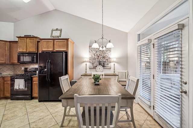 419 Symphony Way, Freeport, FL 32439 - dining room featuring a chandelier, light tile patterned floors, and high vaulted ceiling
