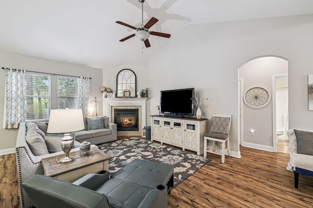 419 Symphony Way, Freeport, FL 32439 - living room with a ceiling fan, arched walkways, vaulted ceiling, wood finished floors, and a fireplace