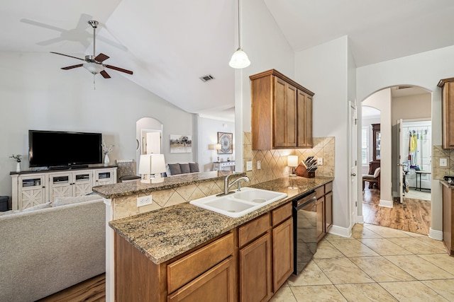 419 Symphony Way, Freeport, FL 32439 - kitchen featuring dishwashing machine, arched walkways, open floor plan, a ceiling fan, and decorative backsplash