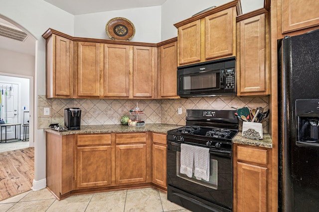 419 Symphony Way, Freeport, FL 32439 - kitchen featuring black appliances, light stone counters, tasteful backsplash, and brown cabinetry