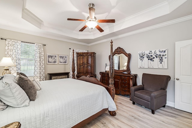 419 Symphony Way, Freeport, FL 32439 - bedroom featuring a raised ceiling, light wood-style floors, ornamental molding, and ceiling fan