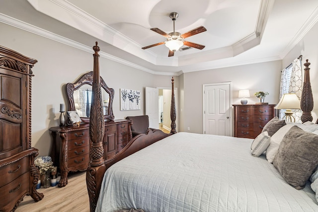 419 Symphony Way, Freeport, FL 32439 - bedroom featuring a tray ceiling, light wood-style floors, crown molding, and ceiling fan