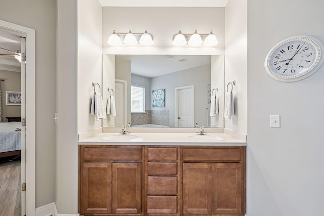 419 Symphony Way, Freeport, FL 32439 - ensuite bathroom with ceiling fan, double vanity, and a bath