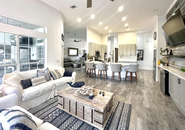 83 Azure Pl, Miramar Beach, FL 32550 - living area featuring a ceiling fan, a high ceiling, light wood-style flooring, beverage cooler, and recessed lighting