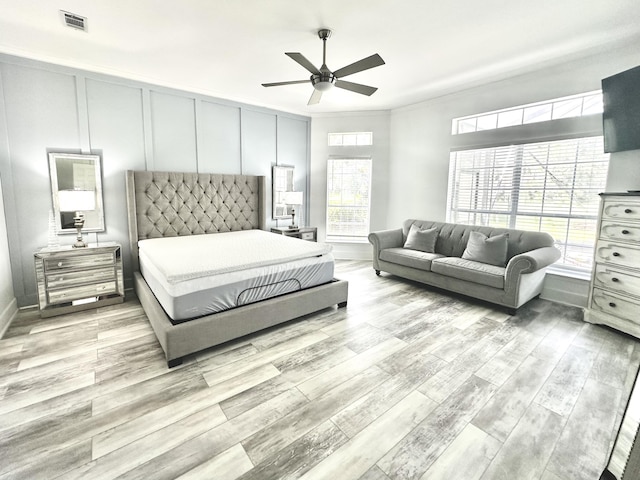 83 Azure Pl, Miramar Beach, FL 32550 - bedroom with light wood-style flooring, a decorative wall, ceiling fan, and ornamental molding
