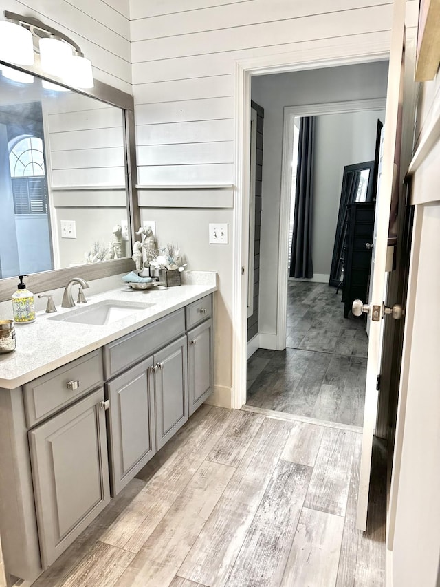 83 Azure Pl, Miramar Beach, FL 32550 - bathroom with vanity, wood finished floors, and wood walls