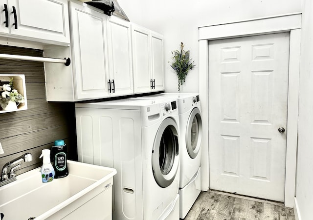 83 Azure Pl, Miramar Beach, FL 32550 - washroom featuring separate washer and dryer, light wood-style floors, and cabinet space