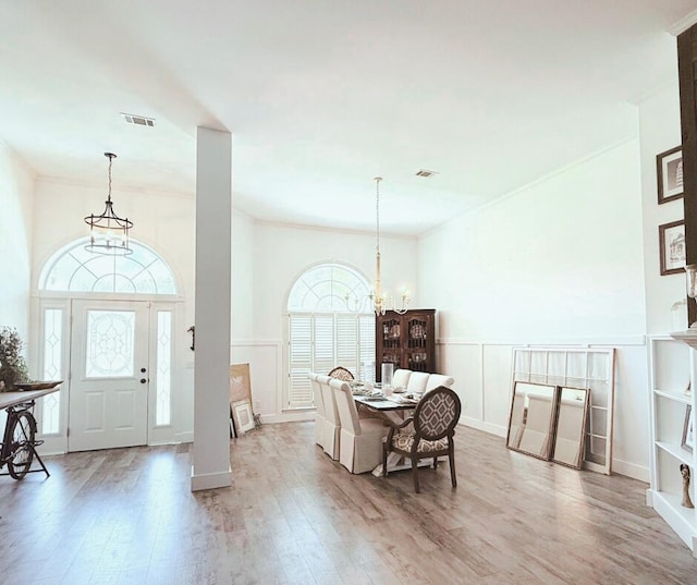 83 Azure Pl, Miramar Beach, FL 32550 - entrance foyer featuring a chandelier, wood finished floors, ornamental molding, and a decorative wall
