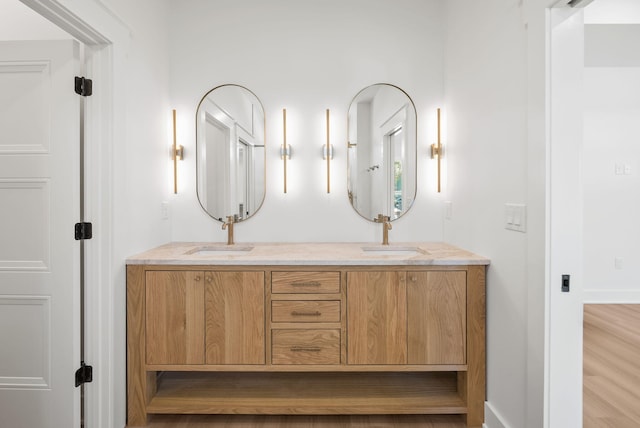 7215 Sunset Ave, Panama City Beach, FL 32408 - bathroom featuring double vanity and wood finished floors