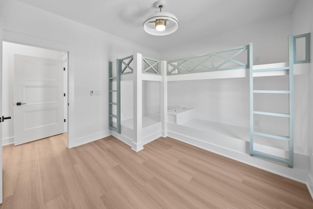7215 Sunset Ave, Panama City Beach, FL 32408 - unfurnished bedroom featuring light wood-type flooring and baseboards