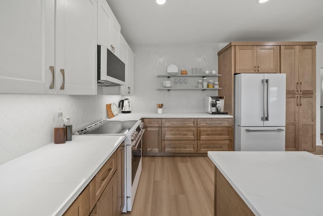 7215 Sunset Ave, Panama City Beach, FL 32408 - kitchen featuring white appliances, light wood-style flooring, backsplash, open shelves, and white cabinets