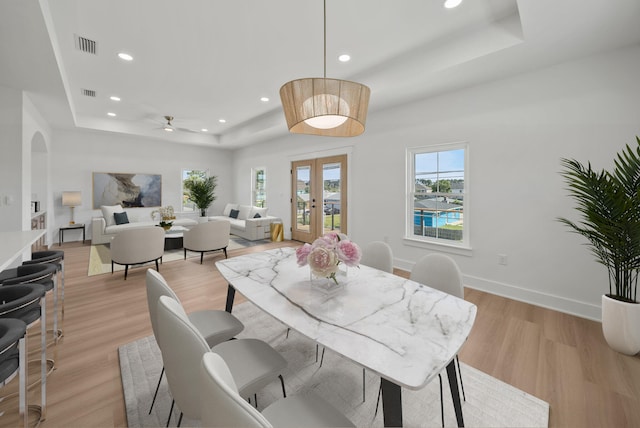 7215 Sunset Ave, Panama City Beach, FL 32408 - dining space featuring a tray ceiling, recessed lighting, light wood-style floors, french doors, and a ceiling fan