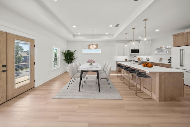 7215 Sunset Ave, Panama City Beach, FL 32408 - dining area with a raised ceiling, light wood-type flooring, and recessed lighting