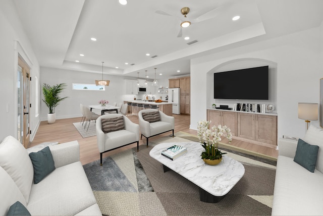7215 Sunset Ave, Panama City Beach, FL 32408 - living area featuring a tray ceiling, light wood-style flooring, recessed lighting, and ceiling fan