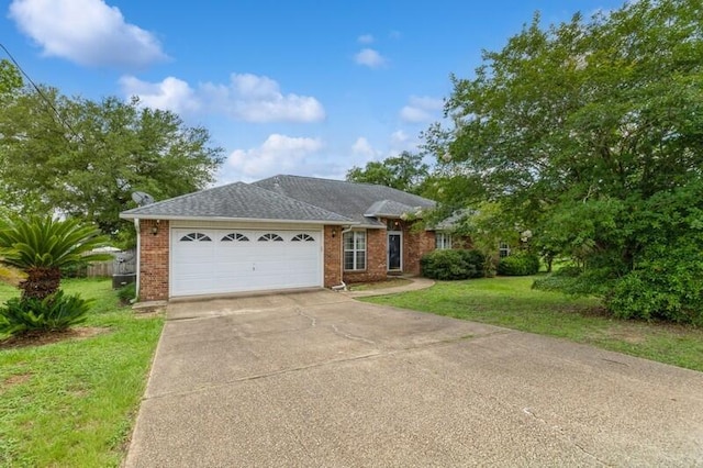 527 Tom Sawyer Ln, Crestview, FL 32536 - ranch-style home with brick siding, an attached garage, driveway, and a front yard