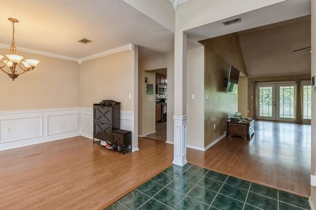 527 Tom Sawyer Ln, Crestview, FL 32536 - empty room with dark wood-style floors, a chandelier, ornamental molding, and wainscoting