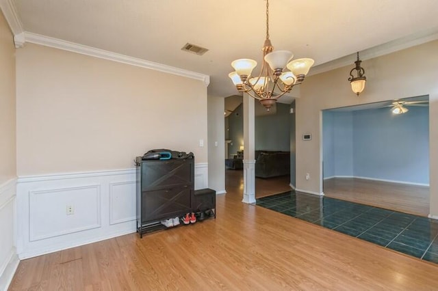 527 Tom Sawyer Ln, Crestview, FL 32536 - dining area with ornamental molding, wood finished floors, a ceiling fan, wainscoting, and a chandelier