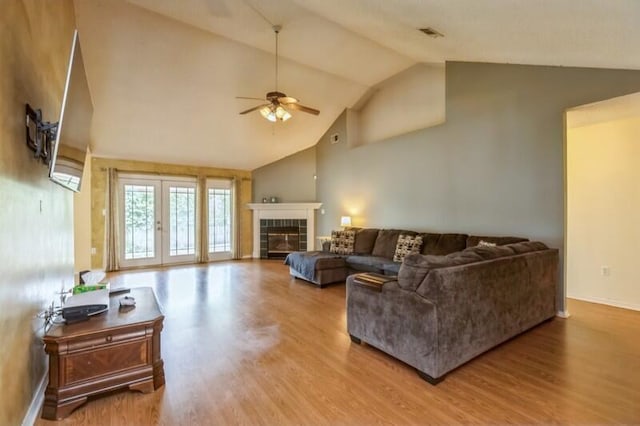 527 Tom Sawyer Ln, Crestview, FL 32536 - living room with ceiling fan, wood finished floors, a fireplace, high vaulted ceiling, and french doors