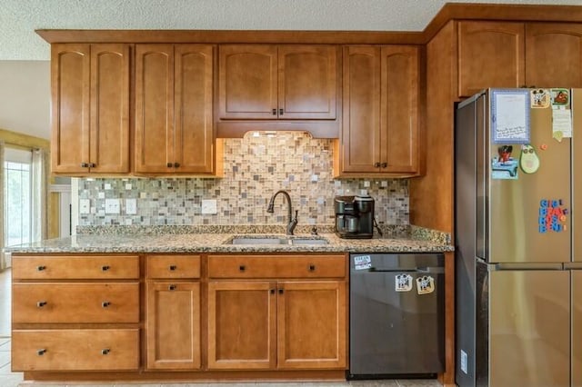 527 Tom Sawyer Ln, Crestview, FL 32536 - kitchen with freestanding refrigerator, black dishwasher, light stone counters, and decorative backsplash