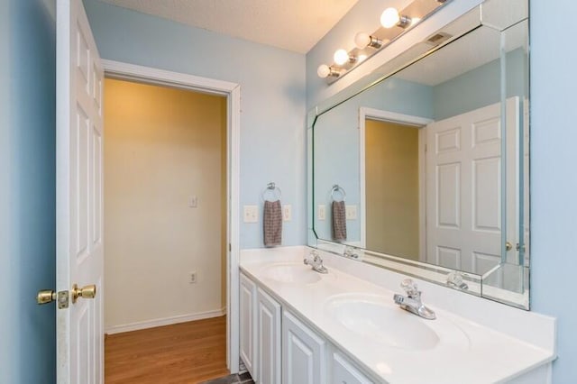 527 Tom Sawyer Ln, Crestview, FL 32536 - bathroom featuring double vanity and wood finished floors