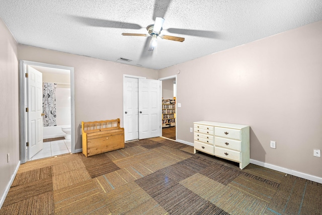 321 Timber Wind Dr, Defuniak Springs, FL 32433 - carpeted bedroom with connected bathroom, a textured ceiling, and ceiling fan