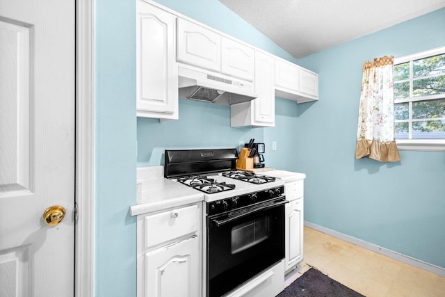 321 Timber Wind Dr, Defuniak Springs, FL 32433 - kitchen featuring gas range oven, under cabinet range hood, light countertops, white cabinetry, and a textured ceiling