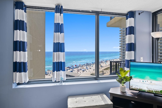 9850 S Thomas Dr Unit 1012W, Panama City, FL 32408 - bedroom with a textured ceiling and a wall of windows