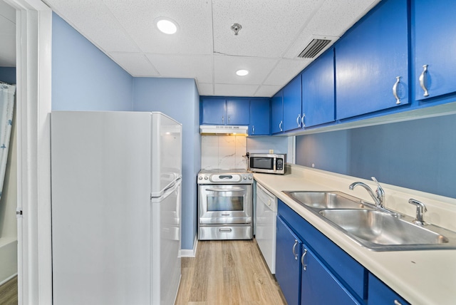 9850 S Thomas Dr Unit 1012W, Panama City, FL 32408 - kitchen featuring appliances with stainless steel finishes, blue cabinetry, under cabinet range hood, light wood-type flooring, and a drop ceiling