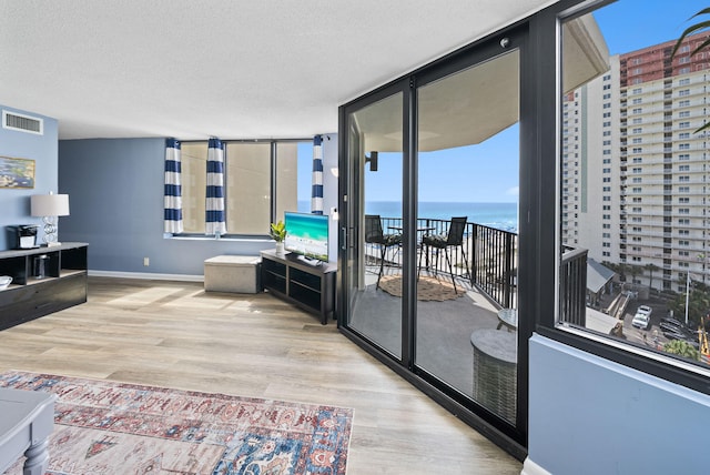 9850 S Thomas Dr Unit 1012W, Panama City, FL 32408 - living area featuring wood finished floors and a textured ceiling