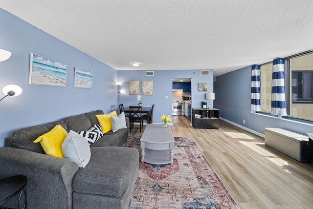 9850 S Thomas Dr Unit 1012W, Panama City, FL 32408 - living area with wood finished floors and a textured ceiling