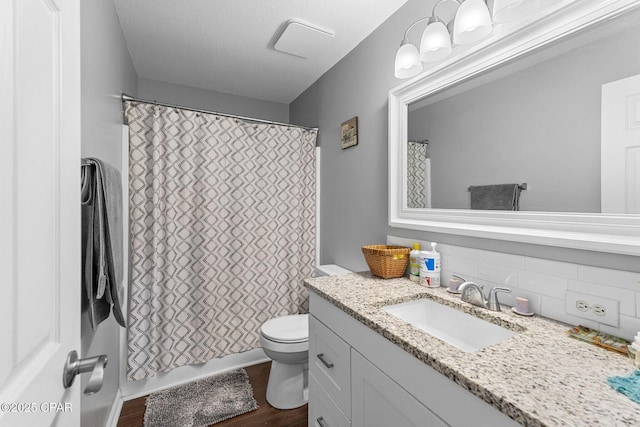 1069 Caswell Rd, Defuniak Springs, FL 32433 - full bathroom featuring vanity, tasteful backsplash, and wood finished floors