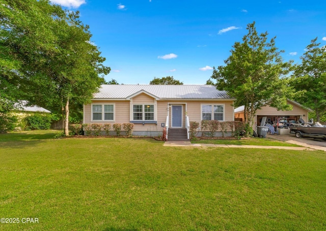 1069 Caswell Rd, Defuniak Springs, FL 32433 - single story home featuring a front yard, a metal roof, concrete driveway, and an attached garage