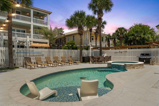 30 Los Angeles St, Miramar Beach, FL 32550 - pool at dusk featuring grilling area, a patio area, and a pool with connected hot tub