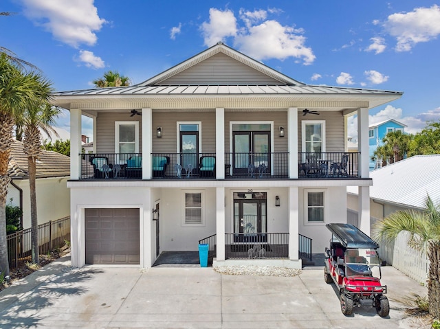 30 Los Angeles St, Miramar Beach, FL 32550 - view of front of house with a balcony, a standing seam roof, ceiling fan, a garage, and a porch
