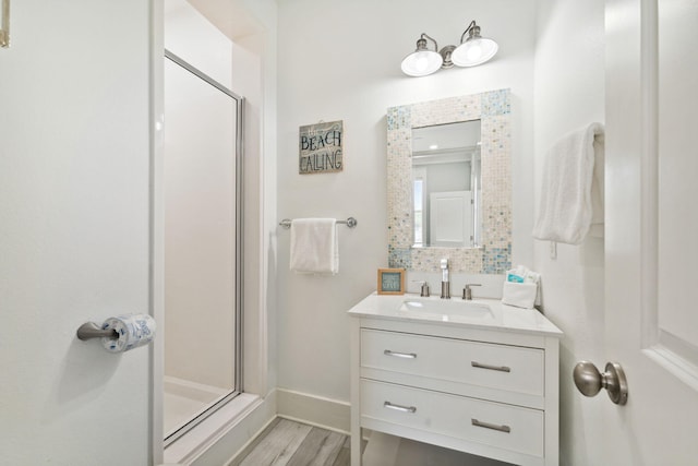 30 Los Angeles St, Miramar Beach, FL 32550 - full bathroom featuring a stall shower, wood finished floors, vanity, and decorative backsplash