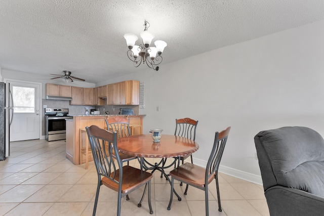 885 Santa Rosa Blvd Unit 208, Fort Walton Beach, FL 32548 - dining area featuring a chandelier, a textured ceiling, light tile patterned floors, and ceiling fan
