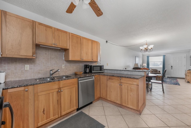 885 Santa Rosa Blvd Unit 208, Fort Walton Beach, FL 32548 - kitchen with appliances with stainless steel finishes, a peninsula, a textured ceiling, backsplash, and a ceiling fan