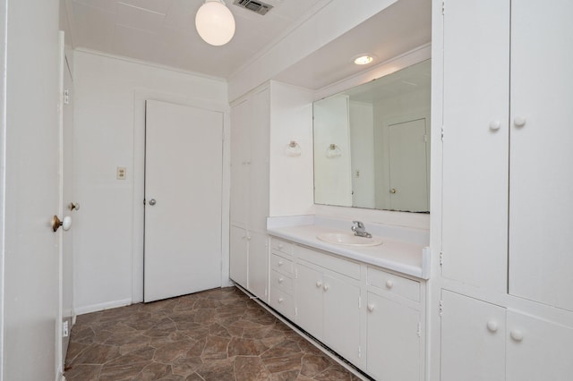 942 Varnum Rd, Laurel Hill, FL 32567 - bathroom featuring vanity, stone finish flooring, and ornamental molding