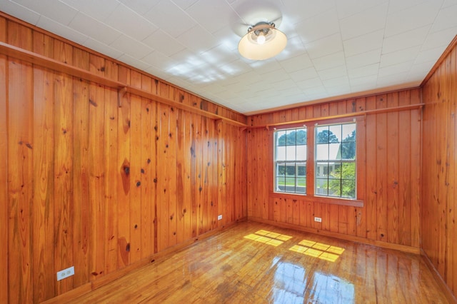 942 Varnum Rd, Laurel Hill, FL 32567 - spare room featuring hardwood / wood-style flooring and wooden walls