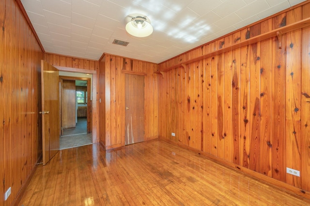 942 Varnum Rd, Laurel Hill, FL 32567 - spare room with hardwood / wood-style flooring and wooden walls