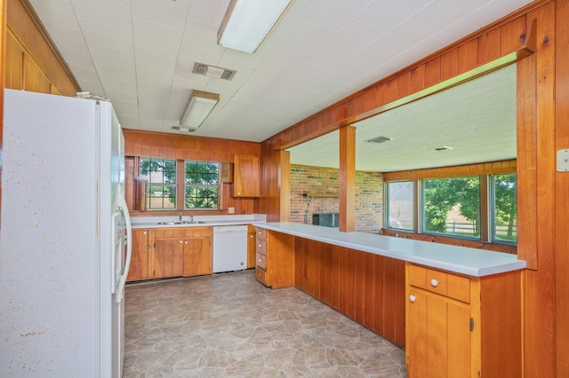 942 Varnum Rd, Laurel Hill, FL 32567 - kitchen with white appliances, light countertops, light stone finish floors, brown cabinets, and a fireplace