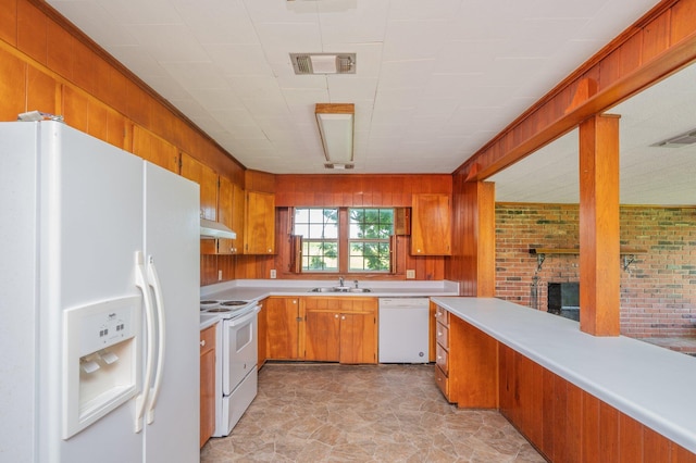 942 Varnum Rd, Laurel Hill, FL 32567 - kitchen featuring white appliances, under cabinet range hood, light countertops, a fireplace, and brown cabinetry