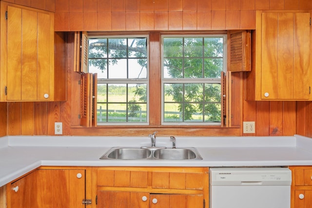942 Varnum Rd, Laurel Hill, FL 32567 - kitchen featuring white dishwasher, light countertops, healthy amount of natural light, and wooden walls