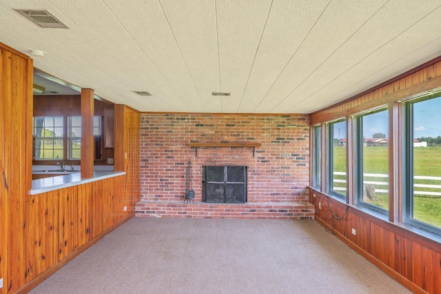 942 Varnum Rd, Laurel Hill, FL 32567 - unfurnished sunroom with wood walls and carpet flooring