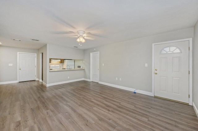 613 Colonial Dr Apt 5, Fort Walton Beach, FL 32547 - unfurnished living room featuring a ceiling fan and wood finished floors