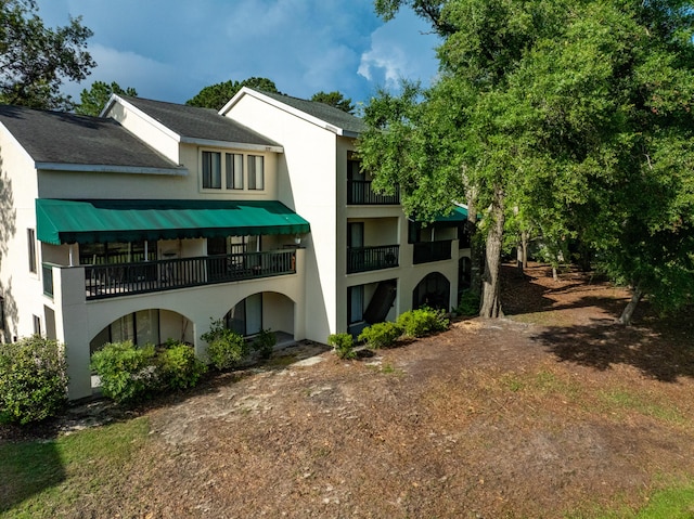 310 Westlake Ct Unit 310, Niceville, FL 32578 - back of house with stucco siding and a balcony