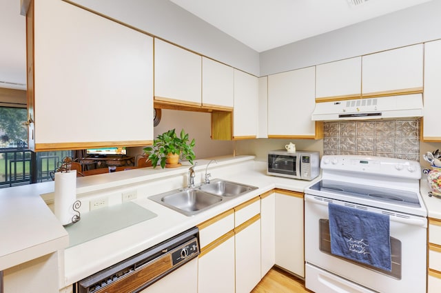310 Westlake Ct Unit 310, Niceville, FL 32578 - kitchen featuring white appliances, range hood, light countertops, and white cabinets