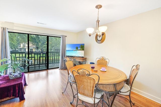 310 Westlake Ct Unit 310, Niceville, FL 32578 - dining room with a chandelier and wood finished floors