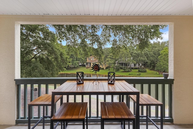 310 Westlake Ct Unit 310, Niceville, FL 32578 - balcony with outdoor dining area and view of wooded area