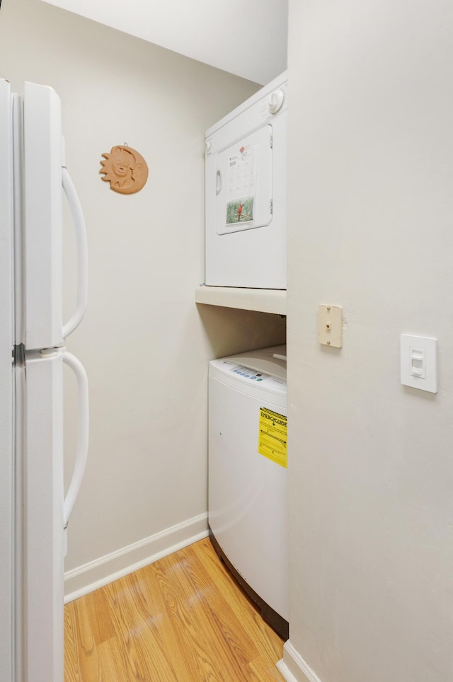 310 Westlake Ct Unit 310, Niceville, FL 32578 - washroom featuring stacked washer and clothes dryer and light wood-style floors